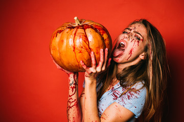 Beautiful Young woman as sexy vampire in blue dress - halloween portrait. Gory bloody and scary...