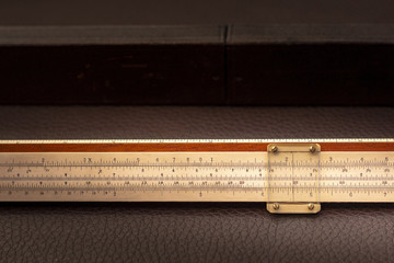 Close up shot of a antique 1915 slide rule, vintage retro concept.