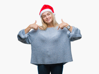 Young caucasian woman wearing christmas hat over isolated background looking confident with smile...