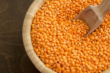 Red dry lentils in a bamboo bowl.