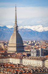 Fototapeta na wymiar The Mole Antonelliana against snow caped Alps, Turin, Italy
