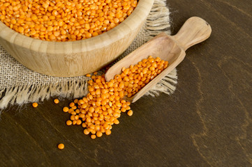 Red dry lentils in a bamboo bowl.