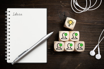 Symbole auf Würfeln am Arbeitsplatz verdeutlichen Ideenfindung durch Teamwork