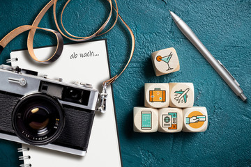 Reisesymbole auf Würfeln, Notizblock mit Aufschrift 