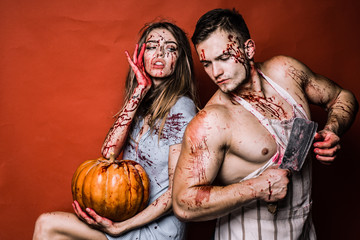 Sexy Vampire Coule with dripping blood on her mouth on bloody background. Beauty Sexy Vampire Girl...