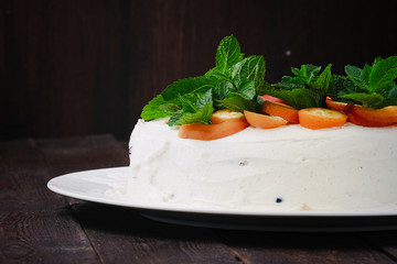 Delocious homemade creampie with kumquat and mint leafs on dark wood background