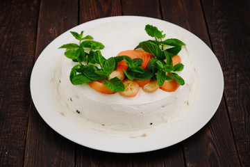 Delocious homemade creampie with kumquat and mint leafs on dark wood background