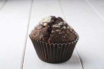 chocolate muffin on white wood background 