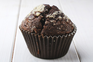 chocolate muffin on white wood background 