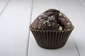 chocolate muffin on white wood background 