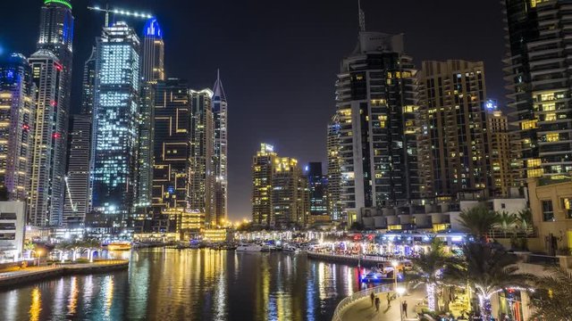 Night timelapse of Dubai. Marina District with skyscrappers and buzzing nightlife