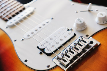 Close up strings of electric guirat on pickups