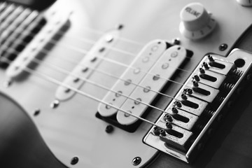 Close up strings of electric guirat on pickups