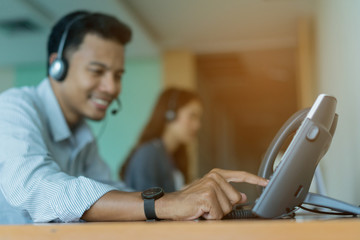 close up employee man hand press number on telephone for contact with someone , technology concept