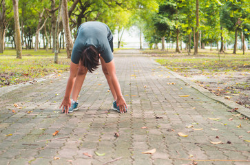Fototapeta premium fitness woman runner stretching legs before run.