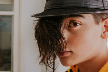 young teenager with long hair to fashion and hat