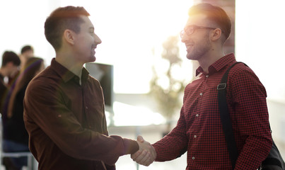 handshake colleagues in the office.