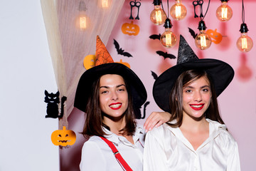 Glamour Fashion Sexy Vampire Lady with witch costume. Black cat sits on a pumkin. Girl witch plays...