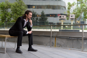 Handsome businessman against view of the city in Bangkok, Thaila