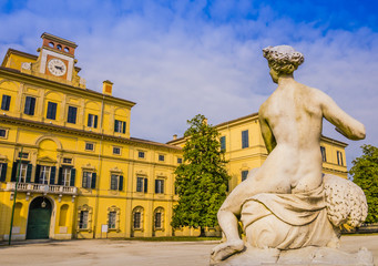 Amazing view of Ducal garden's palace with marble statue in foreground, Parma, Italy
