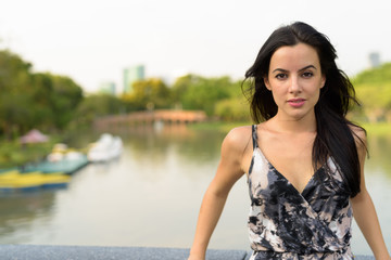 Young beautiful Hispanic woman relaxing in the park