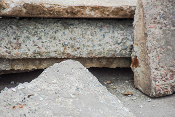 Parts of building blocks on asphalt