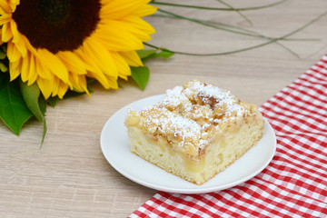 apple cake an sunflower on table