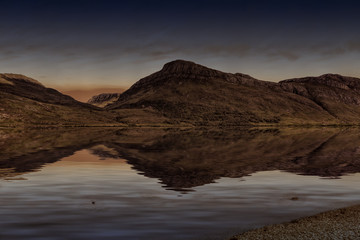 Quiet lake in highlands in the sundown