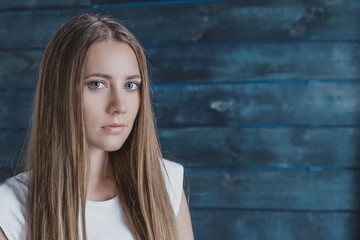 Fototapeta premium portrait of a serious girl on a blue background