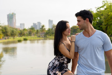 Fototapeta premium Young Hispanic couple relaxing in the park together