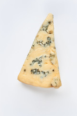 Piece of tasty blue cheese. Delicious Gorgonzola cheese on light background, vertical image. Traditional french cheese.