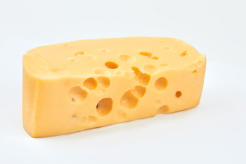 Slice of fresh cheese isolated. Delicious cheese with holes. Healthy meal for breakfast.