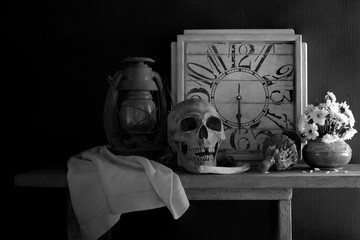 Skull, death and time is true story of nature human  all on the plank dim light