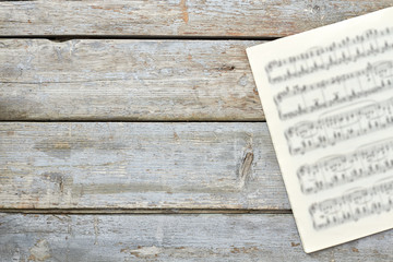 Sheets with musical notes and copy space. Musical papers on old wooden background. Classic music concept. - obrazy, fototapety, plakaty