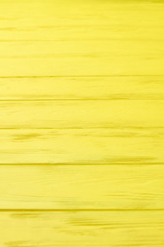Yellow colored wooden boards. Vibrant color horizontal planks background. Abstract wooden surface.
