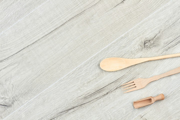 Kitchen wooden utensils on gray wooden background. Wood kitchen ware and copy space. Domestic...