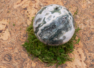 Orbicular ocean jasper sphere with crystallized vugs from Madagascar on moss, bryophyta and cork...