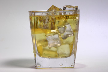 Apple Juice dripping flowing through frosted glass ice cube