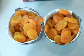 Dried apricots in the bowl . Bowl with dried apricots on white background