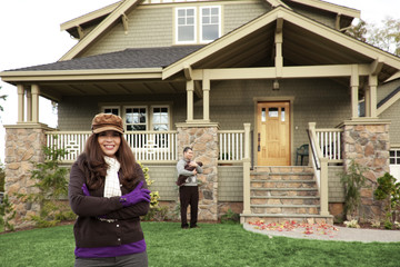 young couple in front of house
