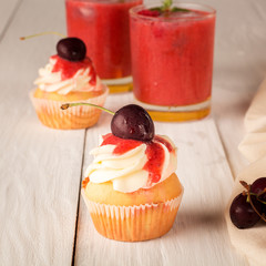 Cupcakes with cherries and berry smoothies