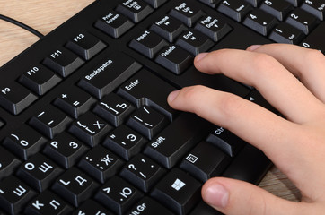 Women's hands typing on a the keyboard