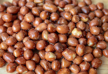 roasted peanuts on wooden background.
