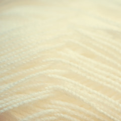 white yarn close-up shot. Woolen threads for knitting  macro. shallow depth of field. Vintage toned. - obrazy, fototapety, plakaty
