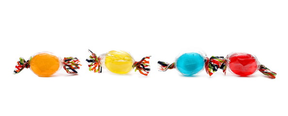 Colorful candies with transparent cellophane wrapping isolated on white background 