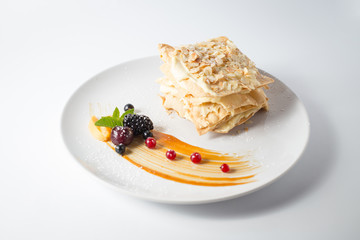 Crispy napoleon with almond chips and berries and mint