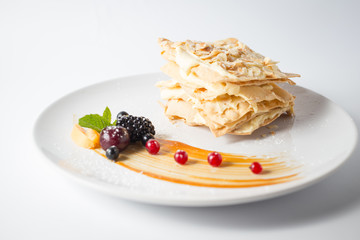 Crispy napoleon with almond chips and berries and mint