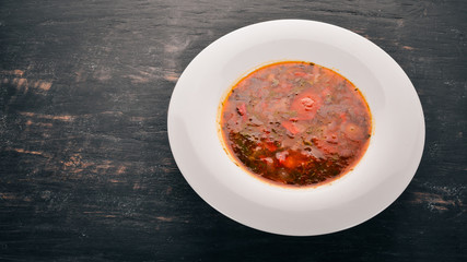 Vegetable soup kharcho. On the old wooden background. Free space for text. Top view.