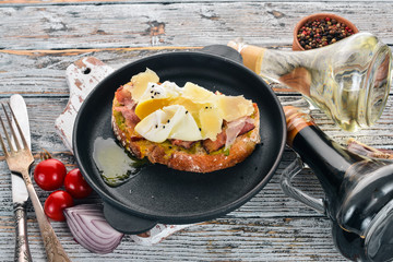 Sandwich with poached egg, avocado and parmesan cheese. On a wooden background. Free space for text. Top view.