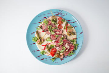 Beef with sause, cucumbers, tomatoes, green and almond